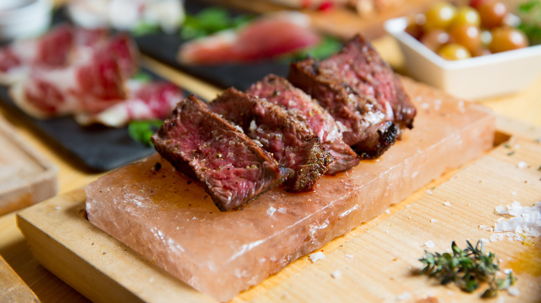 Sliced steak on Himalayan salt block