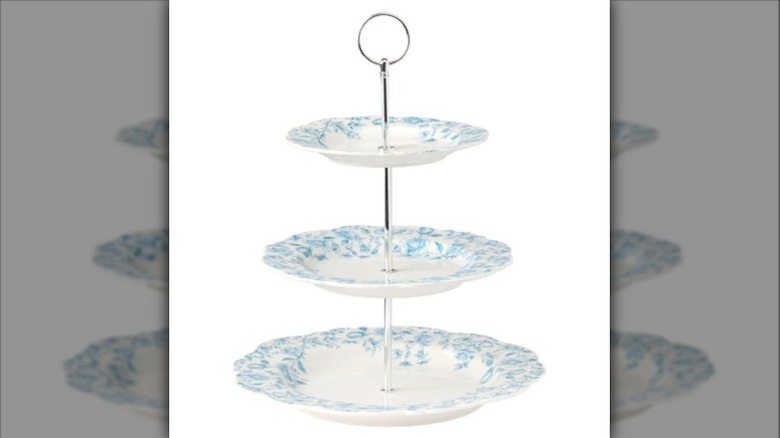 Three-tiered serving dish with blue and white dishes.