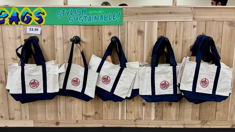 Trader Joe's bags hanging on the wall in a store
