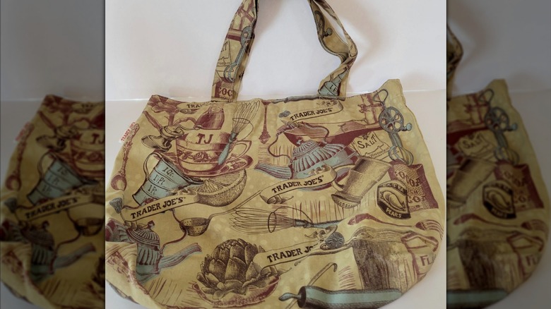 A Trader Joe's tote bag with vintage kitchenware on it