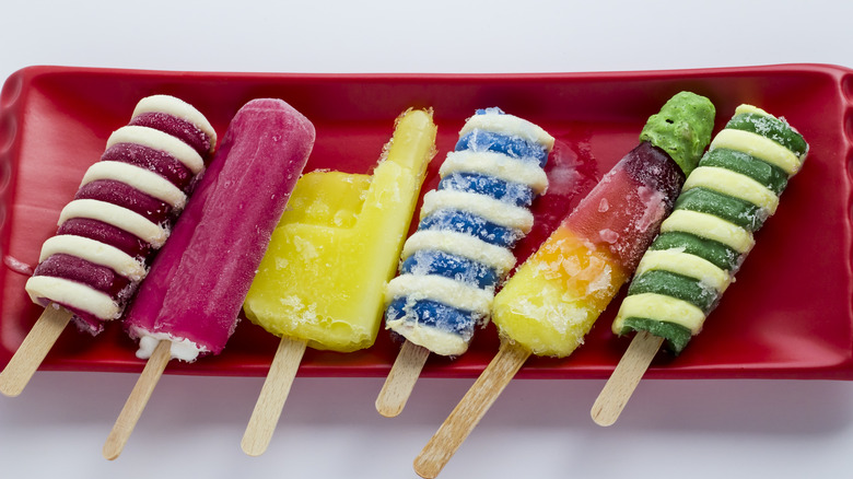 Colorful popsicles on a rectangular red tray