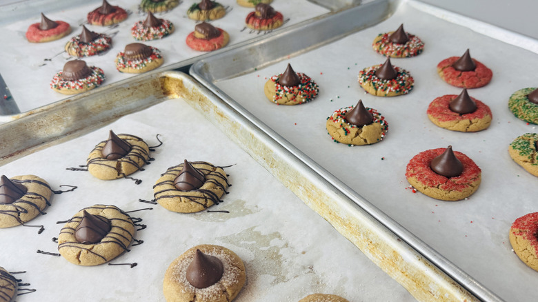 Festive peanut butter blossoms on baking sheets