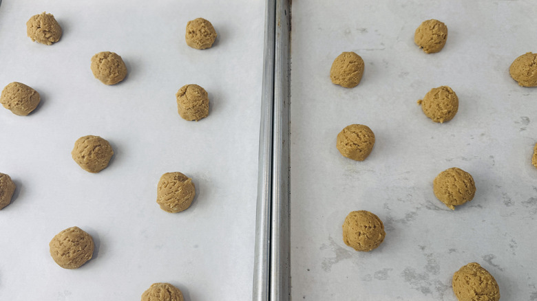 Peanut butter cookie dough scooped onto baking sheets