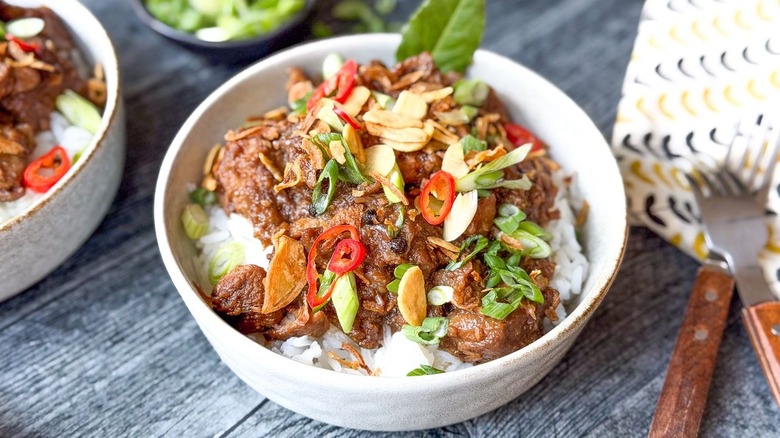 Filipino pork adobo over rice in serving bowl