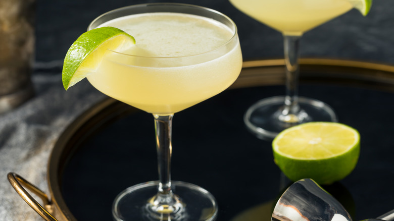 Vodka gimlets in coupe glasses on a tray.