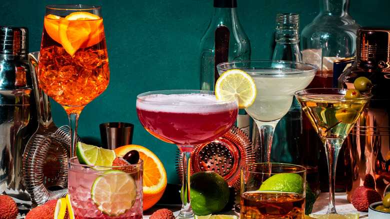 Various cocktails on a green background.