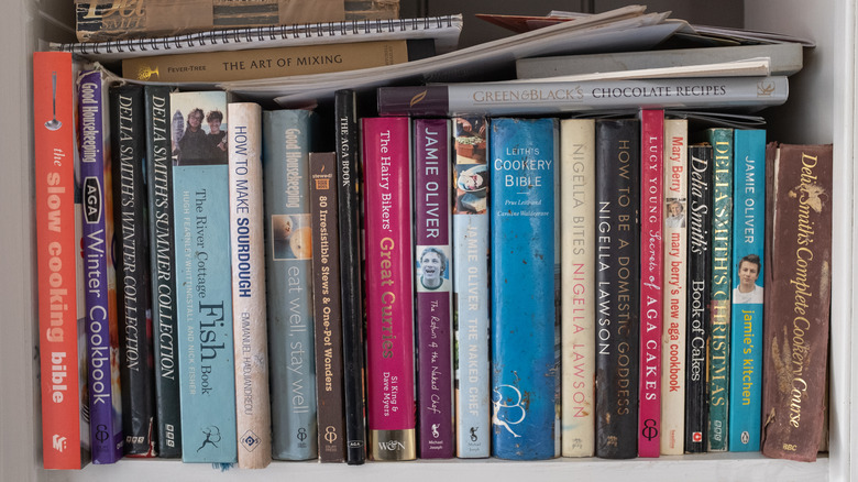 unorganized cookbooks on shelf