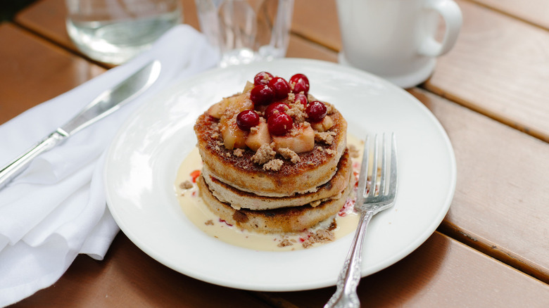 Stack of hot cakes with fruit topping
