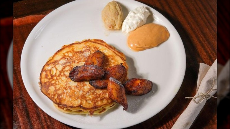 Stack of pancakes topped with caramelized plantains