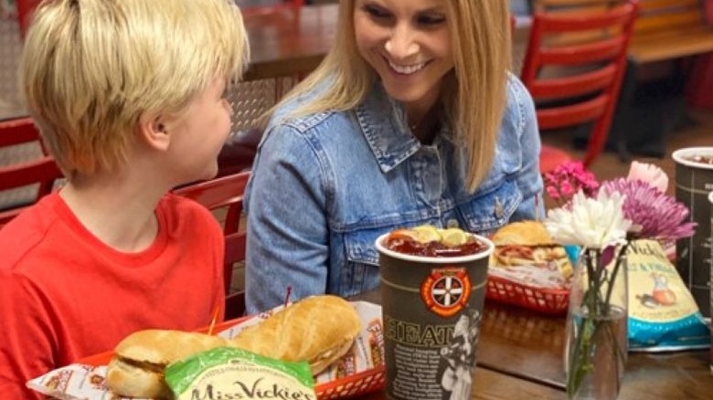 Smiling woman and child enjoying Firehouse Subs' meals