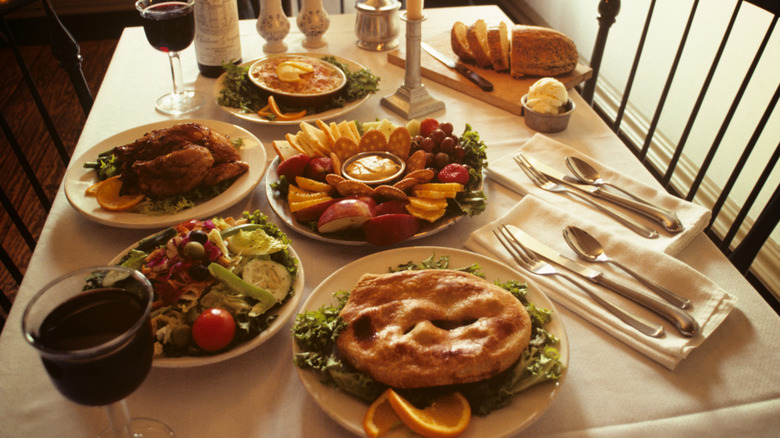 colonial-era table with food and drinks