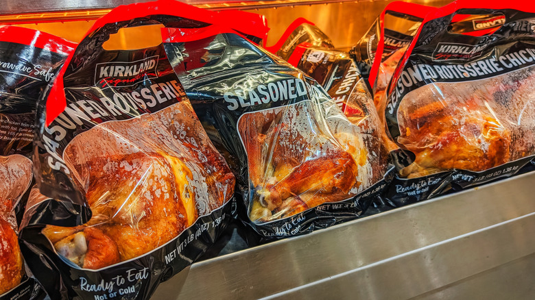 Bags of Kirkland Signature Seasoned Rotisserie Chicken at a Costco warehouse