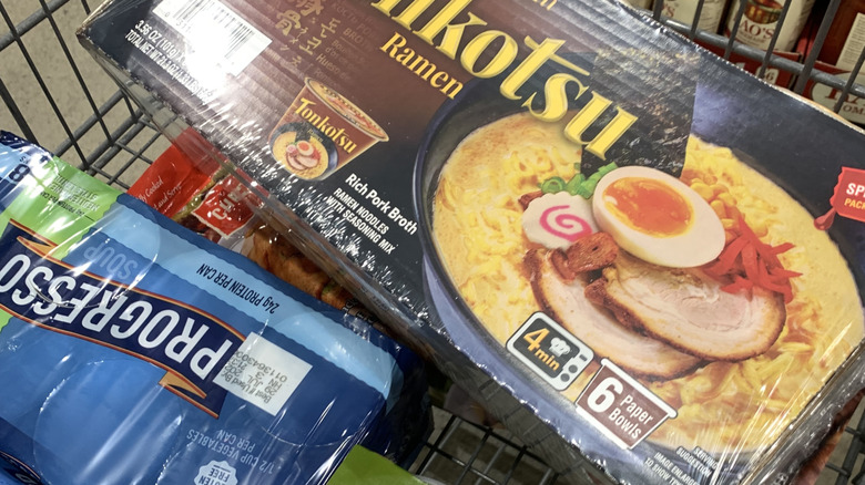 A carton of Nongshim Tonkotsu Ramen in a cart at a Costco warehouse