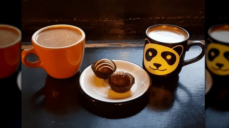 Two mugs of coffee with some chocolates at Chocolati cafe in Seattle.