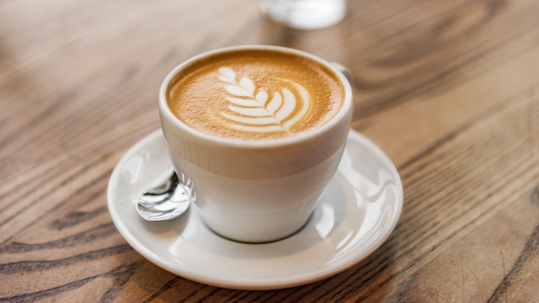 A freshly made latte with art swirled into the foam as is common in Seattle coffee shops.