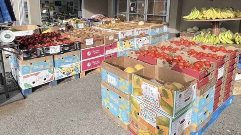 Melons and other fruit in boxes for sale just outside of Lenny's market in northern Seattle.