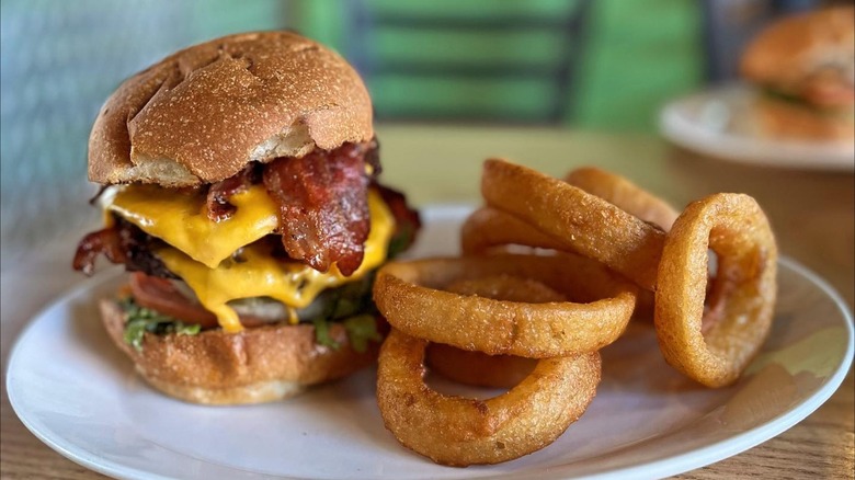 a bacon cheeseburger with onion rings from Rain City Burgers in Seattle