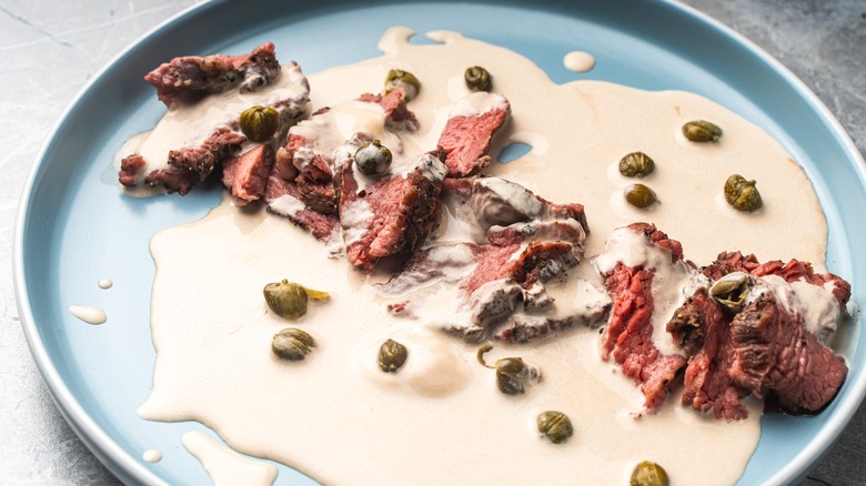 steak topped with anchovy cream sauce