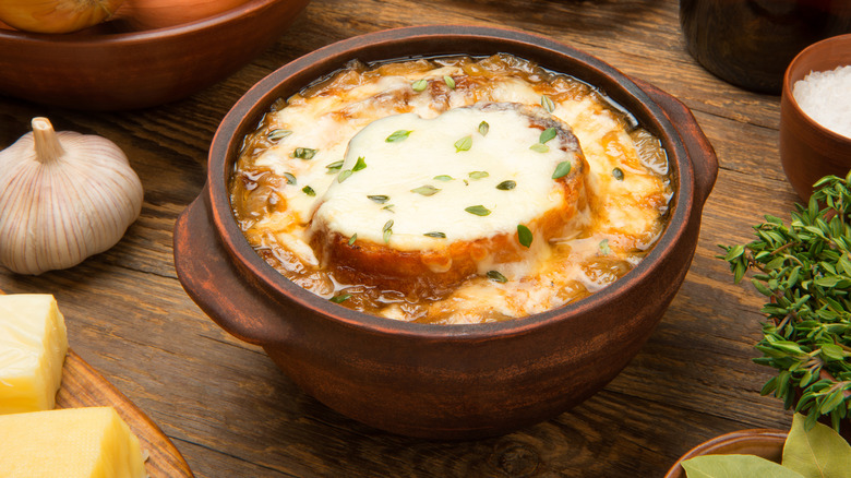 French onion soup in a brown ceramic bowl