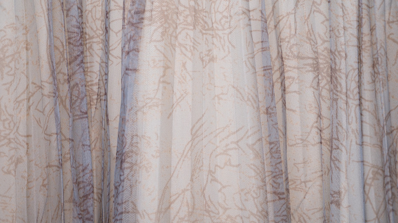 sheer fabric curtains with a subtle flower pattern