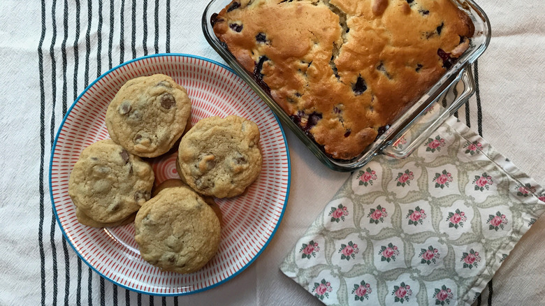 flower dish towel folded next to cake and cookies