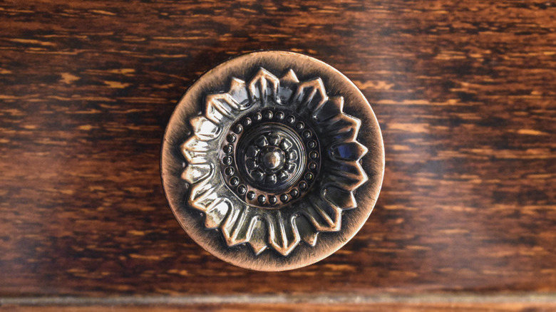 flower knob on wooden drawer