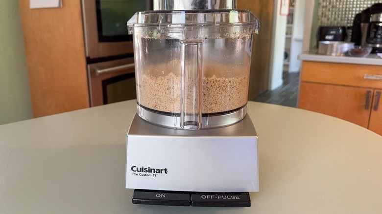 Finely chopped hazelnuts in food processor bowl