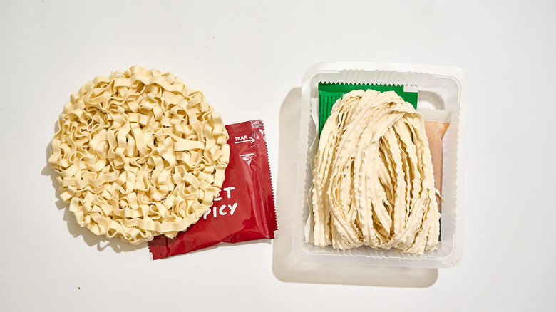 Dry noodles with seasoning packets on a table.