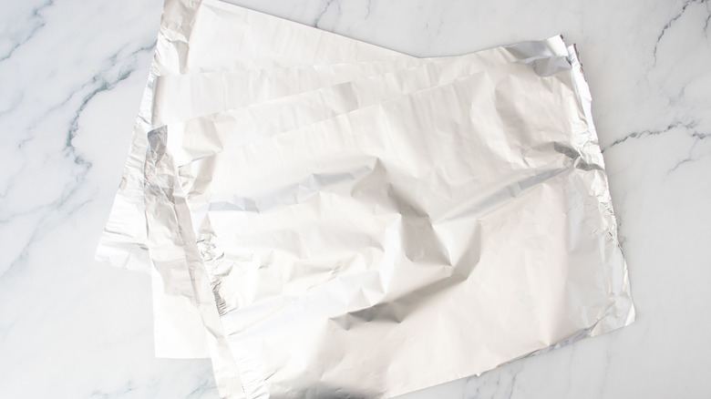 Four large sheets of aluminum foil