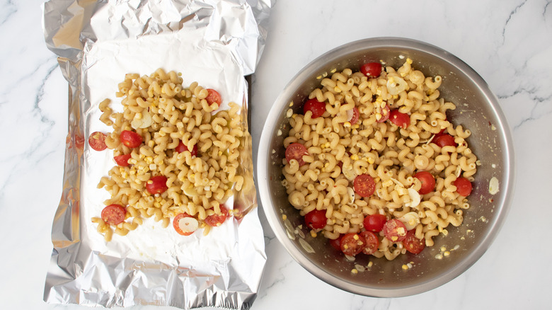 Pasta in a large bowl and pasta on a sheet of foil