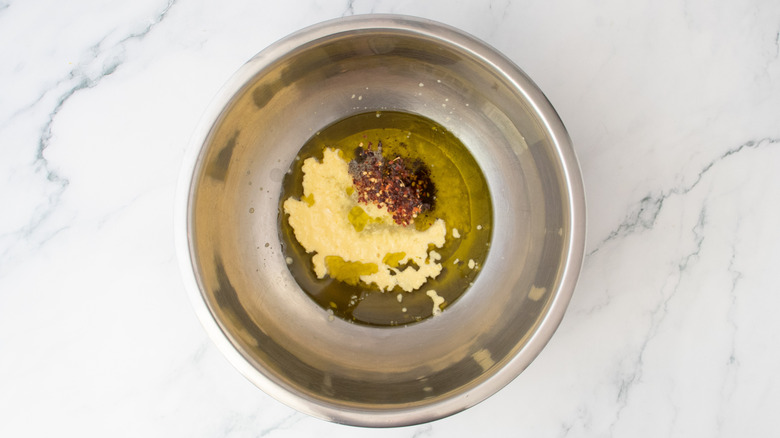 Assorted ingredients in olive oil in a large bowl
