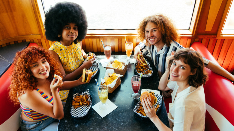 Group of people eating food in a 1980s restaurant