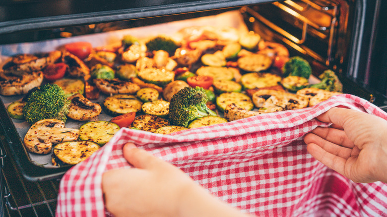 tray of roasted veggies coming out of oven