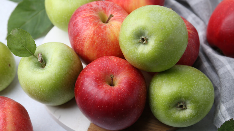 Red and green apples on a table