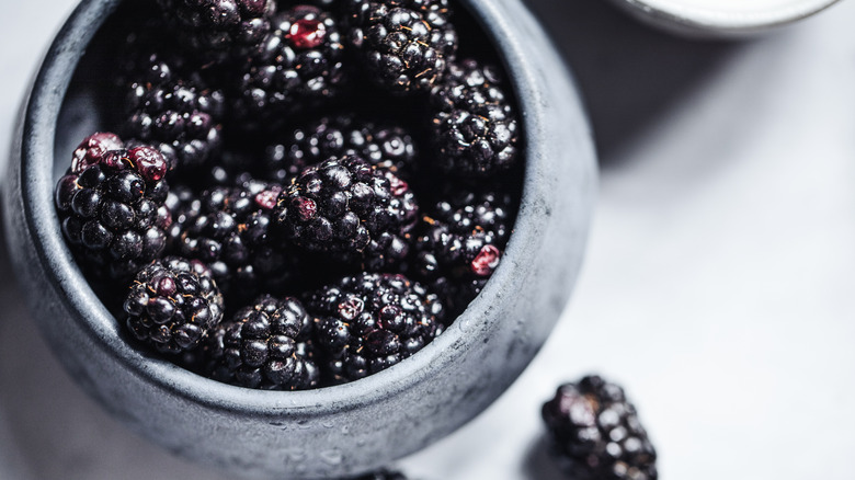 Blackberries in a dark gray stone container