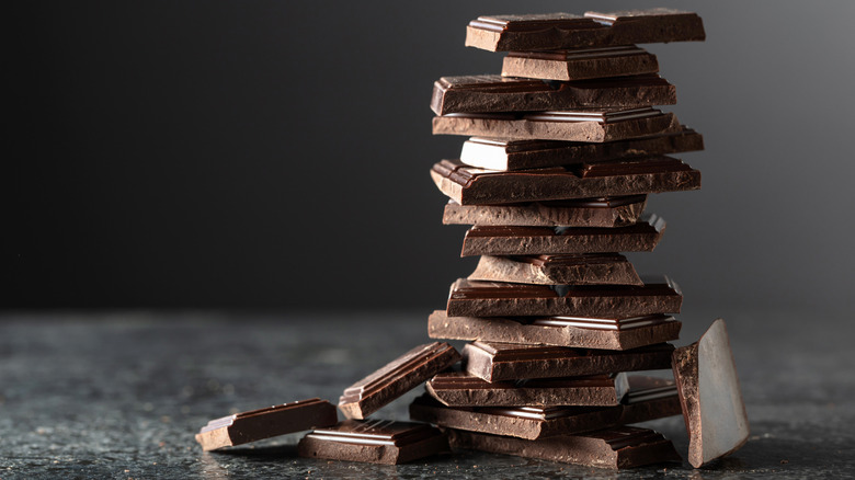 Stack of dark chocolate pieces on a granite countertop