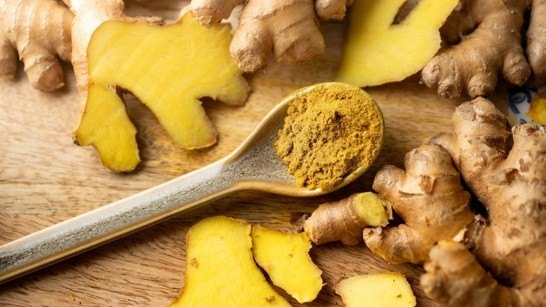Whole, sliced, and grated ginger on a cutting board