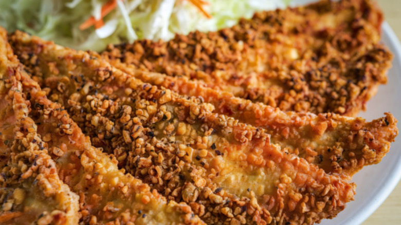 Breaded and fried catfish on a plate