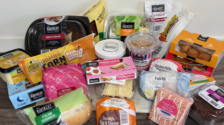 Variety of food items purchased from Kwik Trip on a wooden surface against a white background