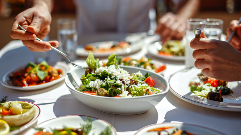 person eating salad at restaurant