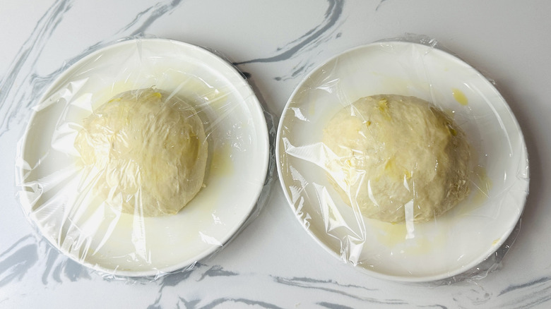 Covered pizza dough on plates