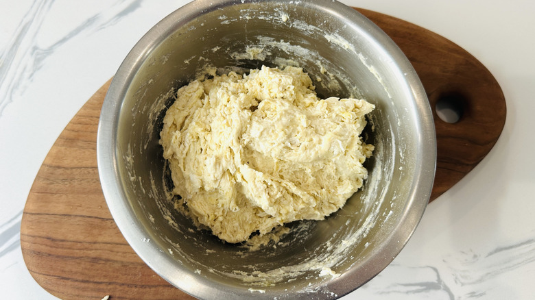 Pizza dough mixed in bowl