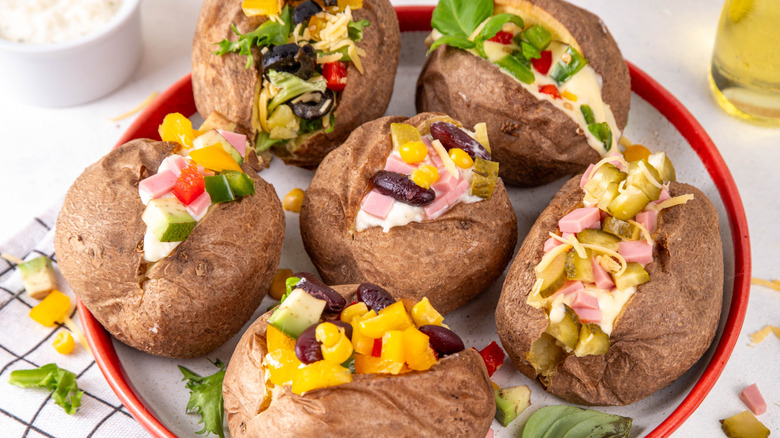 Plate of baked potatoes with various toppings