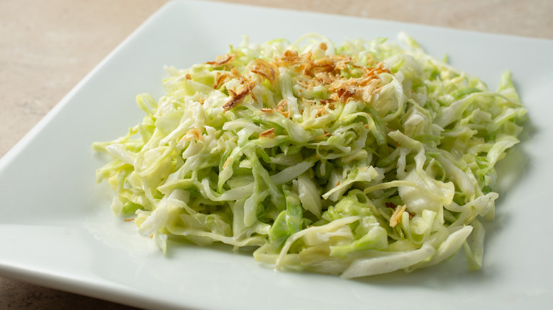 A white plate filled with Japanese cabbage slaw