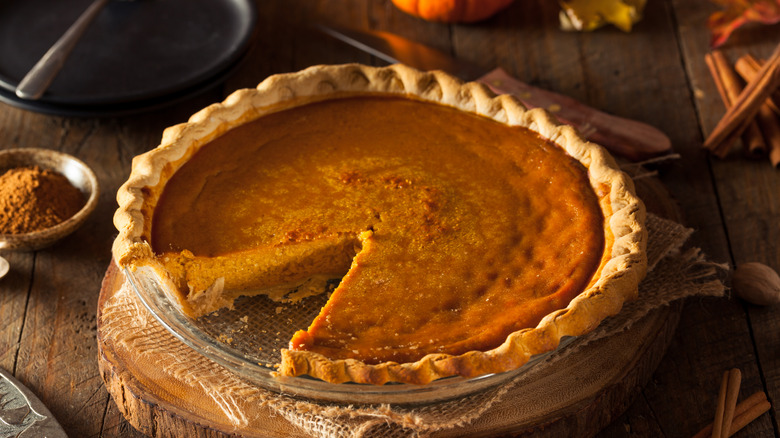 Pumpkin pie on wooden block