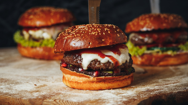 Three burgers with sauces