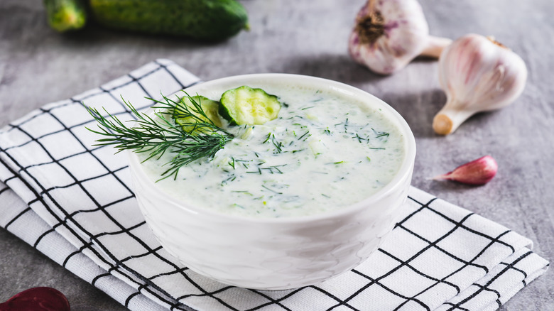 Tzatziki sauce with cucumber, garlic and dill on kefir in a bowl on the table