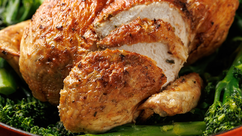 Slice of roasted chicken with crispy, seasoned skin