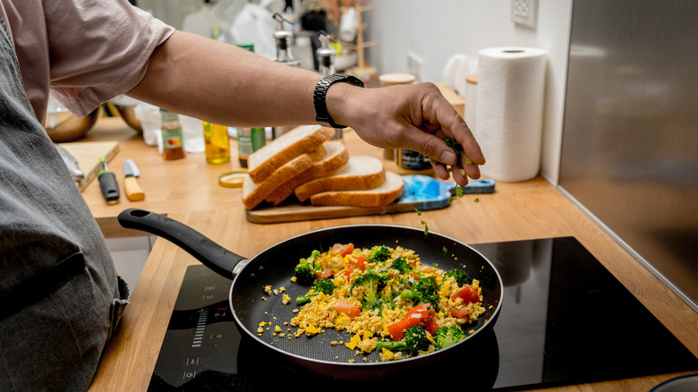 person making tofu scramble