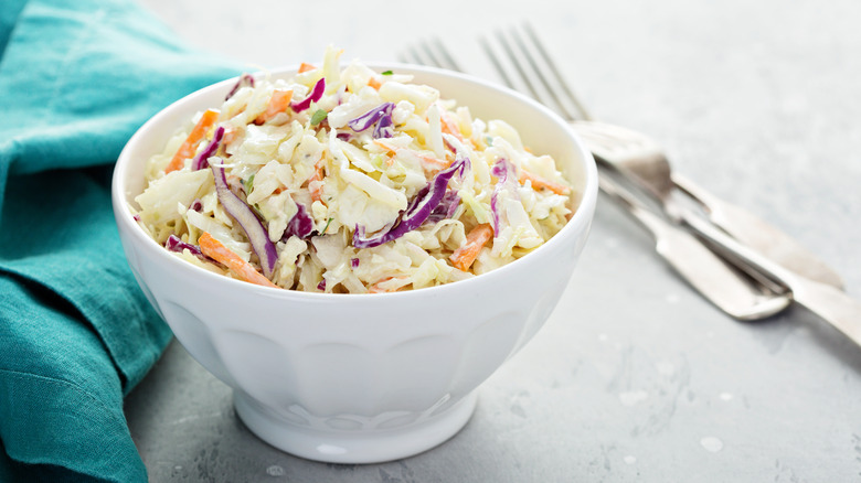 Traditional coleslaw in a white bowl.